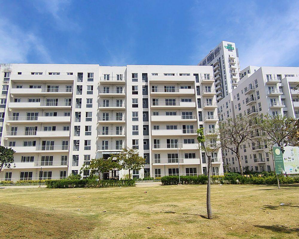 Completed Phase I blocks of Vatika Seven Elements behind a landscaped lawn (actual image)